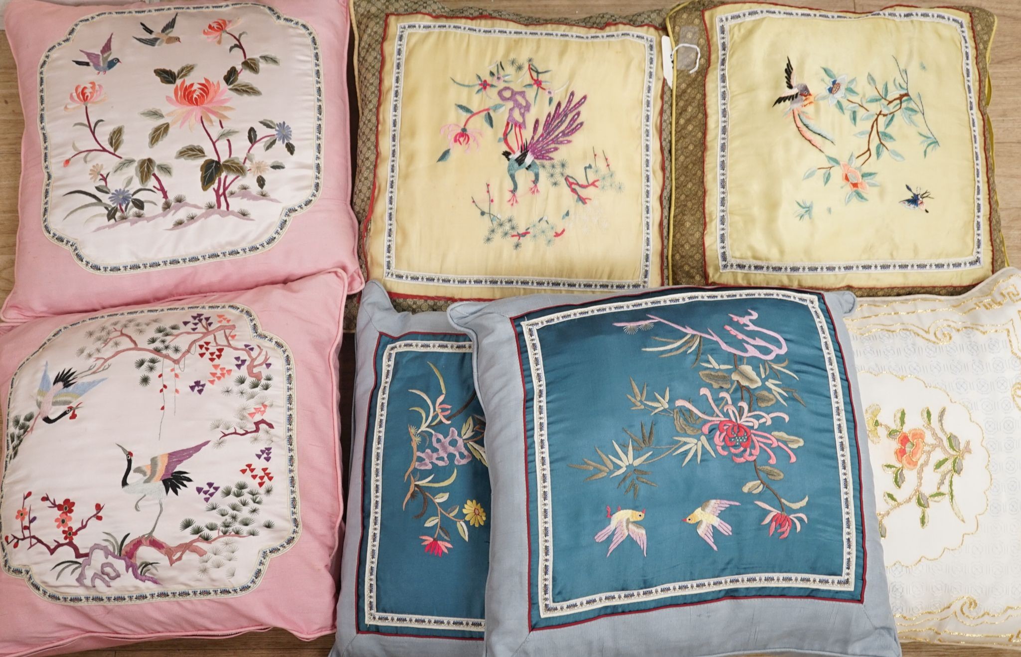 Three pairs of Chinese silk embroidered cushions and a cushion